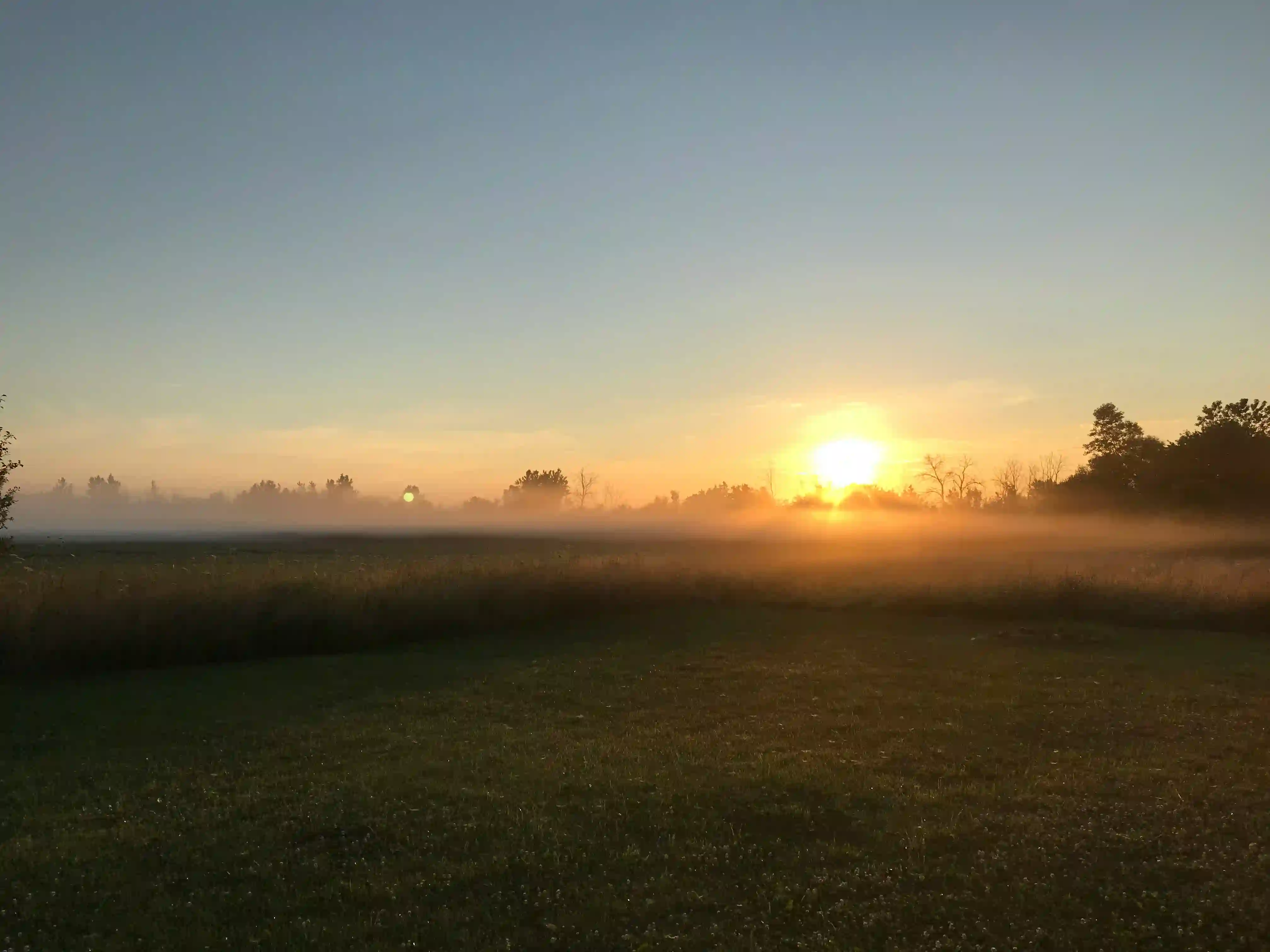 Person greeting the sun on a peaceful morning, illustrating a mindful morning ritual